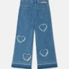 Jeans in denim elasticizzato con toppa a forma di cuore con frange Jeans in denim elasticizzato con toppa a forma di cuore con frange