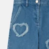 Jeans in denim elasticizzato con toppa a forma di cuore con frange Jeans in denim elasticizzato con toppa a forma di cuore con frange