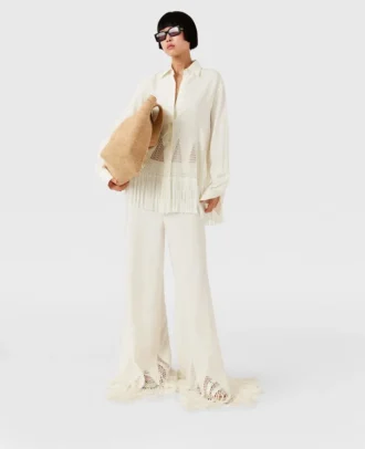 Pantaloni a gamba larga con frange e maglia aperta