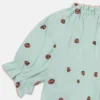 Top Ladybird a maniche corte con bordi plissettati Top Ladybird a maniche corte con bordi plissettati